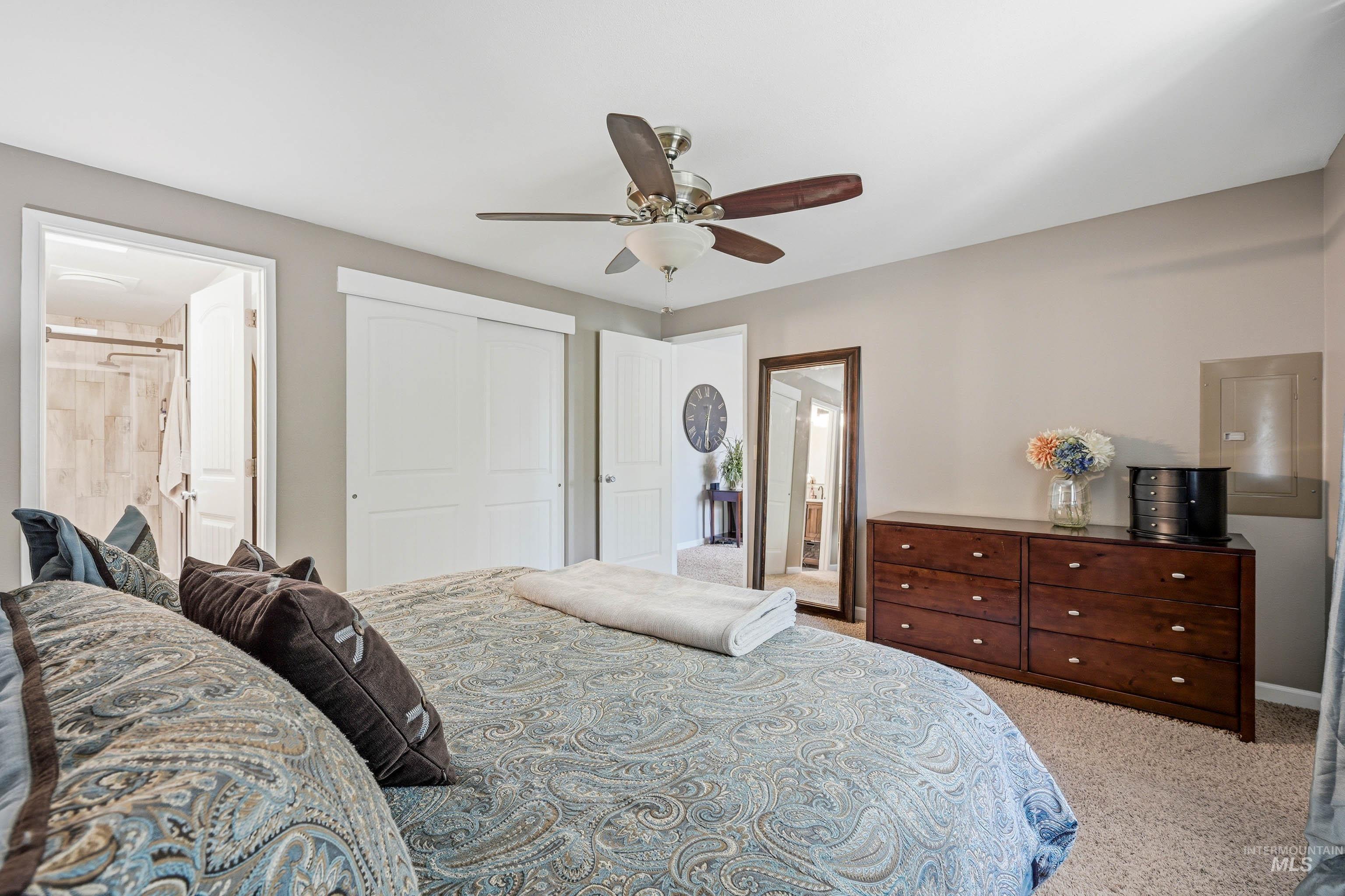 3715 18th Street Lewiston, ID 83501 - Photo 16 of 30 Carpeted bedroom with a ceiling fan light fixture, white interior doors, and a doorway opening to a bathroom with a tiled shower
