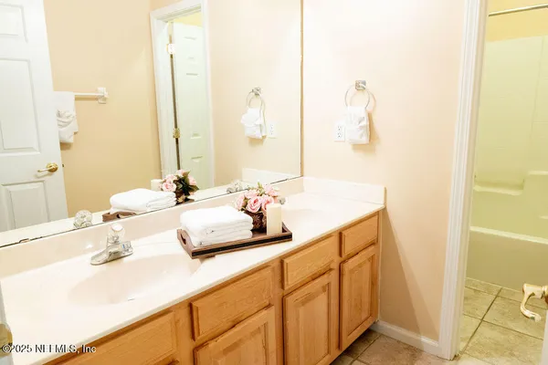 a bathroom with a double vanity sink and a mirror