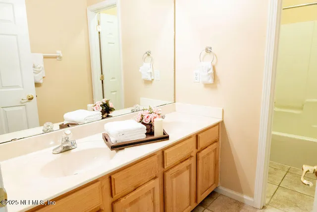 a bathroom with a double vanity sink and a mirror
