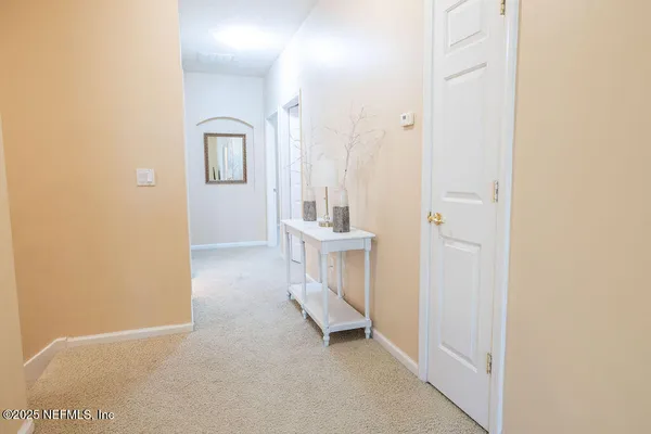 a view of a hallway with a white walls