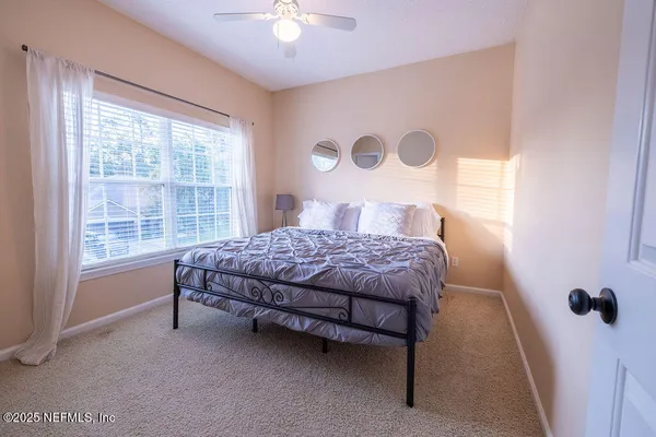 a bedroom with a bed and a window