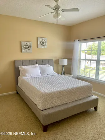 a bedroom with a bed and window