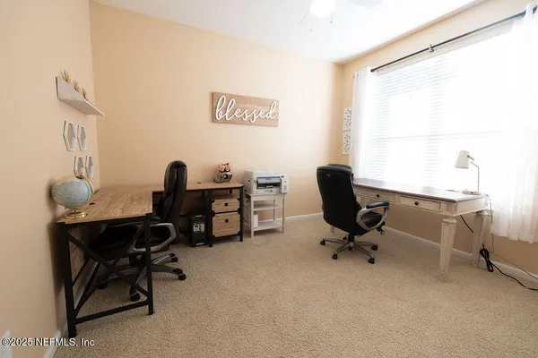 a view of a workspace with furniture