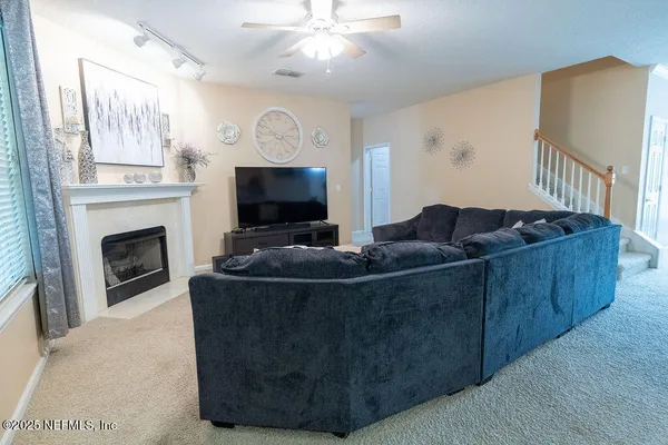 a living room with furniture and a fireplace