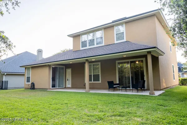 a view of a house with backyard porch and garden