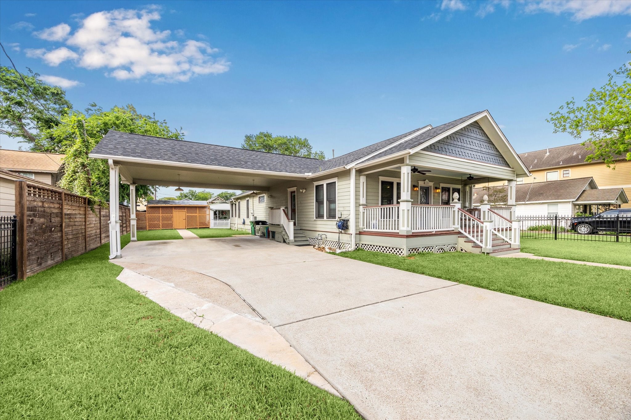 1321 West 21st Street Houston, TX 77008 - Photo 2 of 31 Spacious driveway with covered carport provides ample off-street parking. Extended concrete drive allows for multiple vehicles. Side yard access adds convenience and functionality.