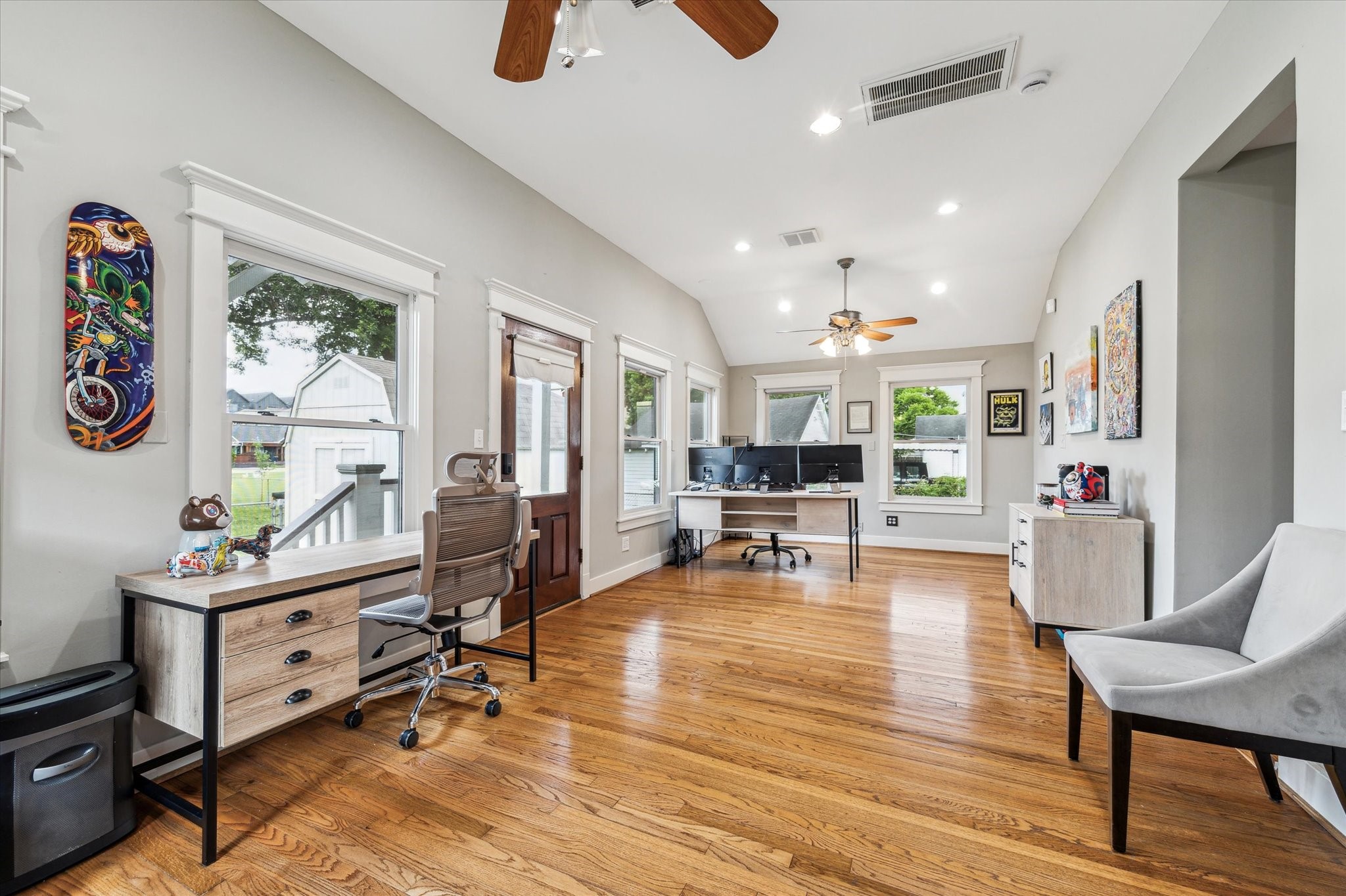 1321 West 21st Street Houston, TX 77008 - Photo 8 of 31 The open layout easily accommodates workstations, seating, or creative use, while ceiling fans and updated lighting enhance comfort and functionality. Convenient access to outdoor areas adds to the room’s adaptability, making it ideal for today’s flexible lifestyle needs.