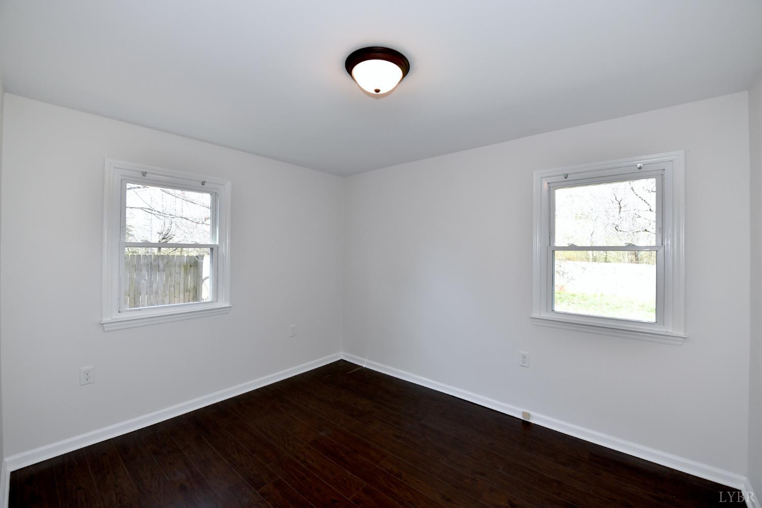 5763 3 Creeks Road Gladys, VA 24554 - Photo 17 of 25 a view of an empty room with wooden floor and a window