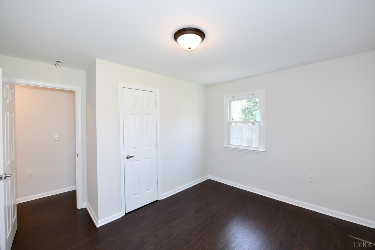 5763 3 Creeks Road Gladys, VA 24554 - Photo 18 of 25 a view of an empty room with wooden floor and a window