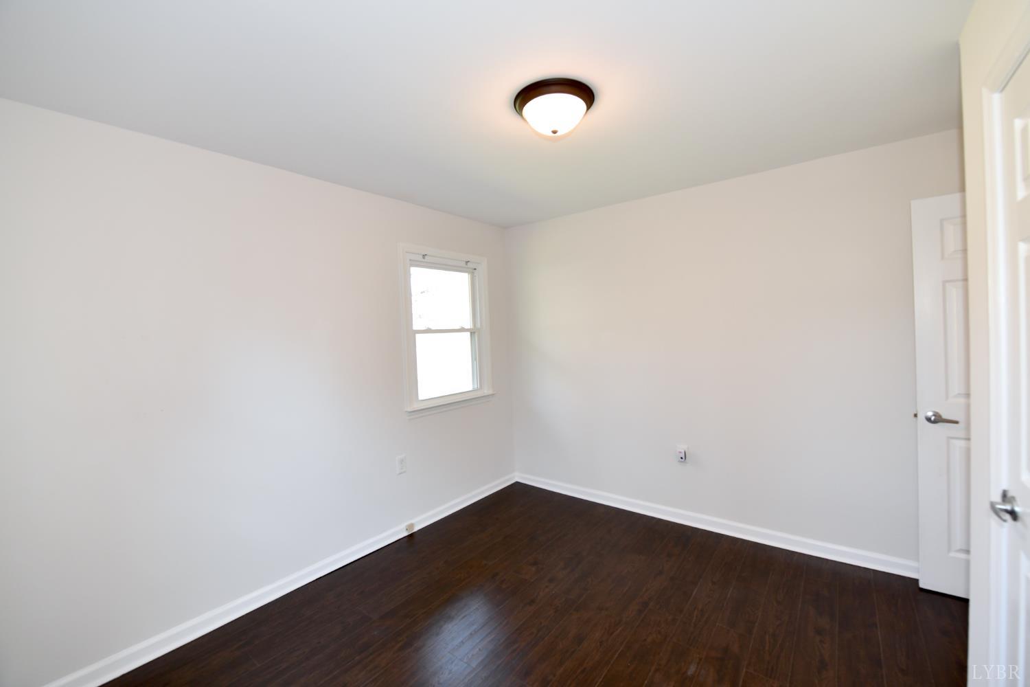 5763 3 Creeks Road Gladys, VA 24554 - Photo 19 of 25 an empty room with wooden floor and windows