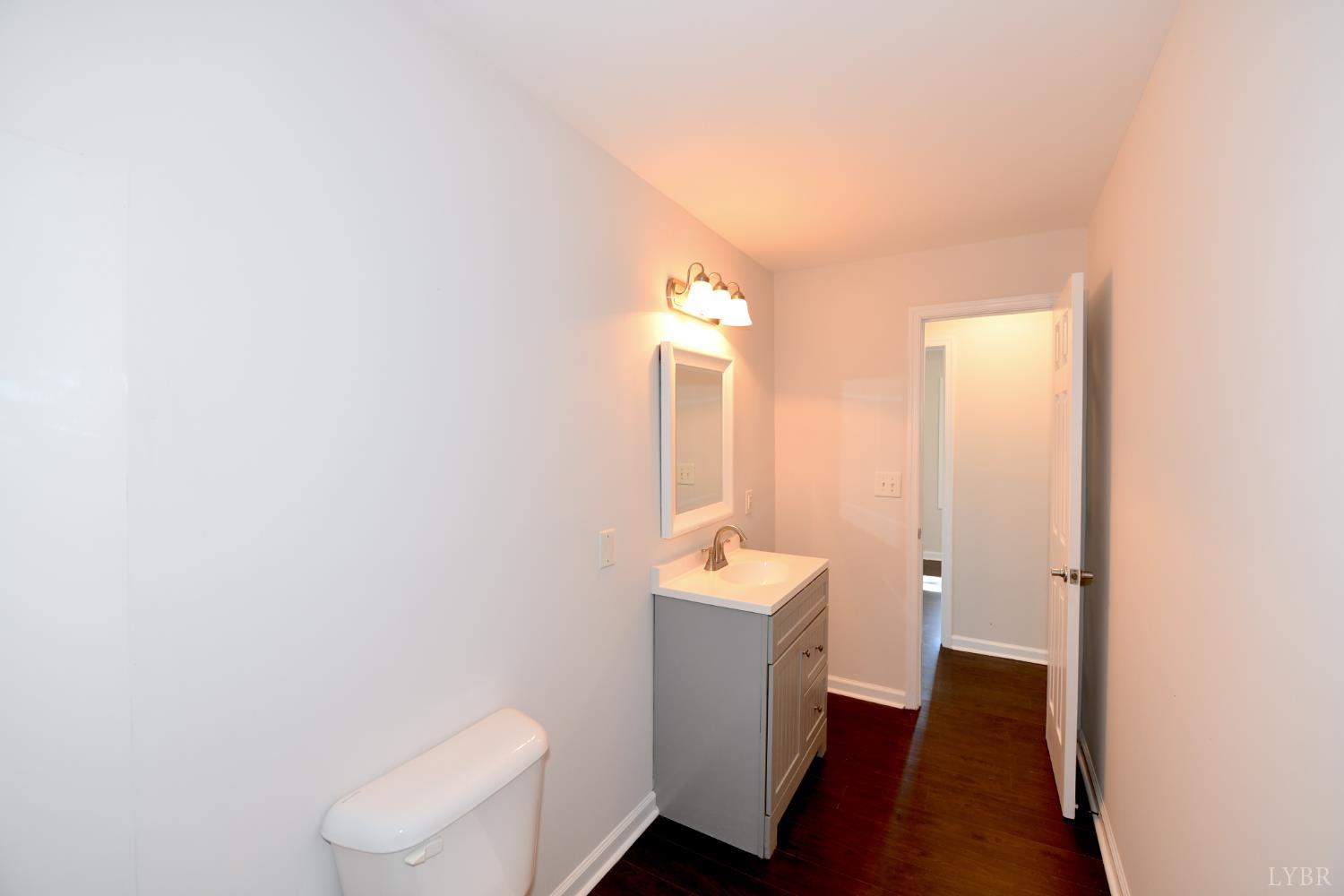 5763 3 Creeks Road Gladys, VA 24554 - Photo 21 of 25 a bathroom with a toilet a sink and mirror