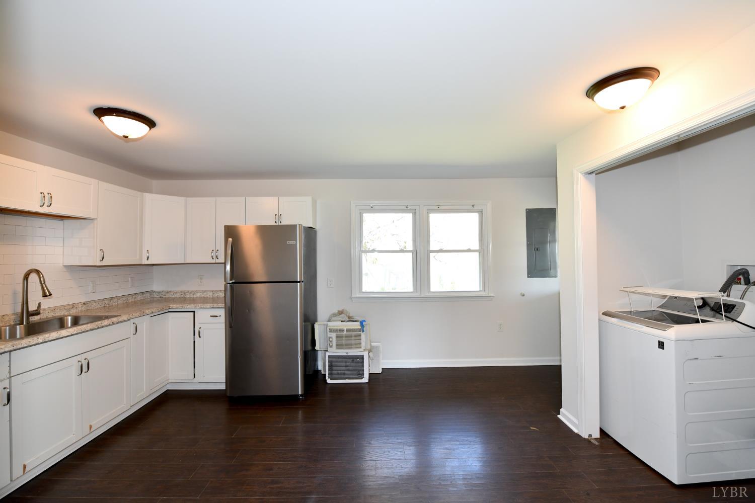 5763 3 Creeks Road Gladys, VA 24554 - Photo 10 of 25 a kitchen with a refrigerator sink and cabinets