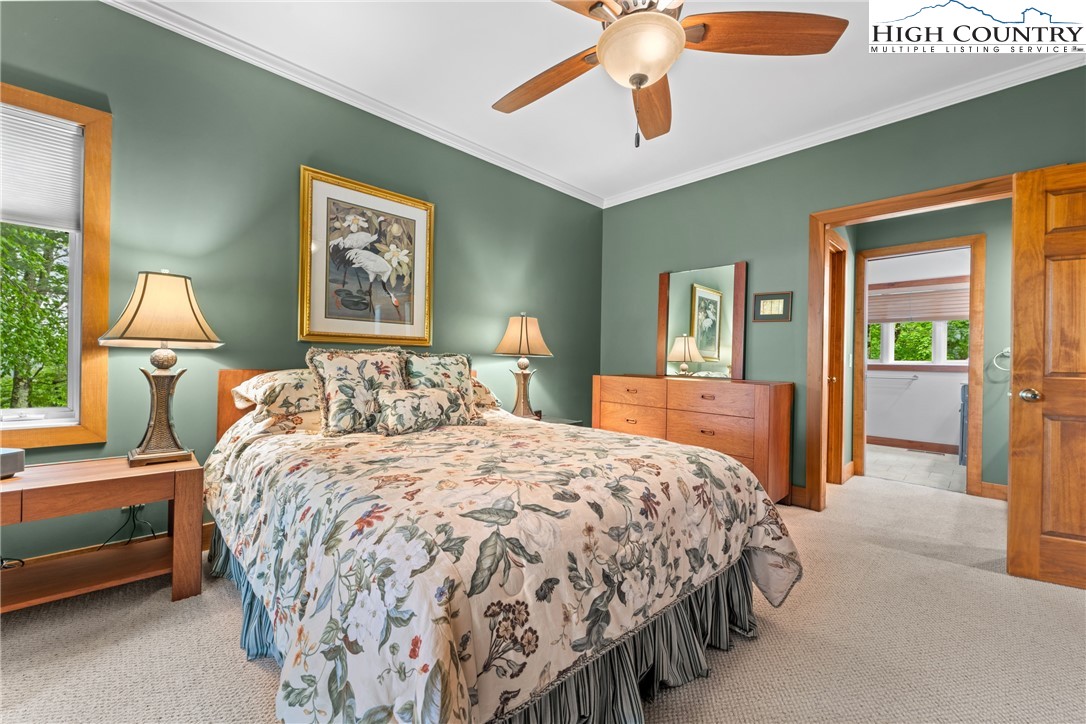 349 Belmont Drive Boone, NC 28607 - Photo 12 of 49 a bedroom with a bed and a chandelier