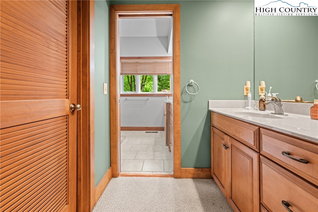 349 Belmont Drive Boone, NC 28607 - Photo 14 of 49 a bathroom with a sink and a mirror