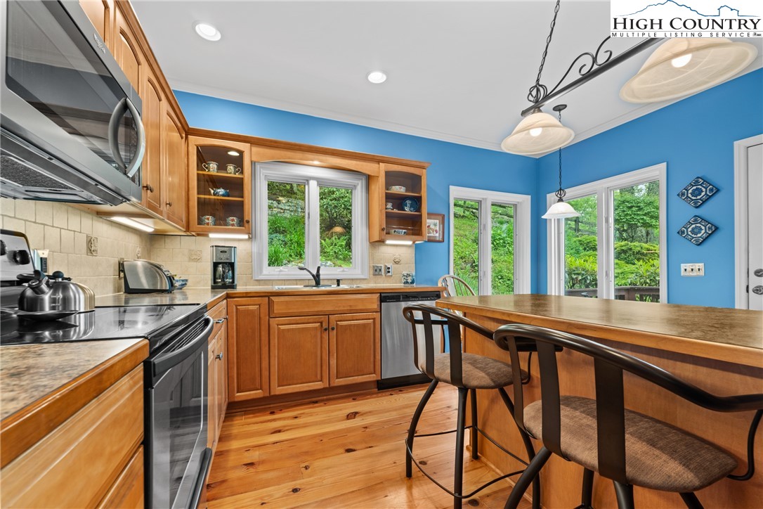 349 Belmont Drive Boone, NC 28607 - Photo 18 of 49 a kitchen with stainless steel appliances granite countertop wooden cabinets a stove a sink and dishwasher
