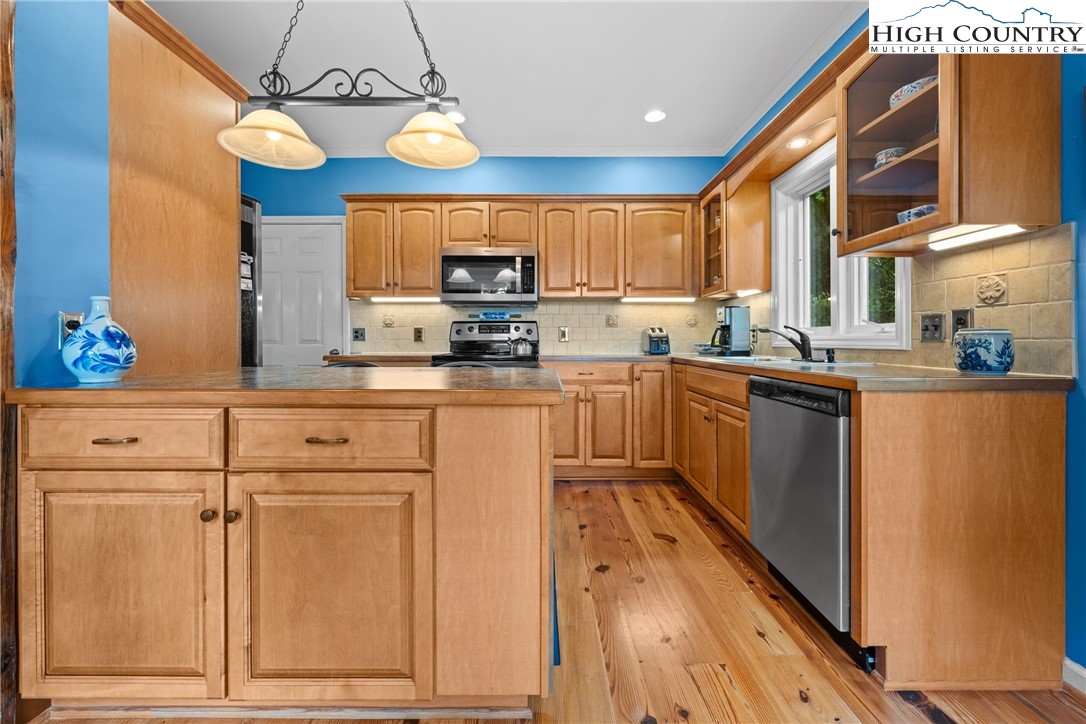 349 Belmont Drive Boone, NC 28607 - Photo 20 of 49 a kitchen with stainless steel appliances granite countertop a sink a stove cabinets and wooden floor