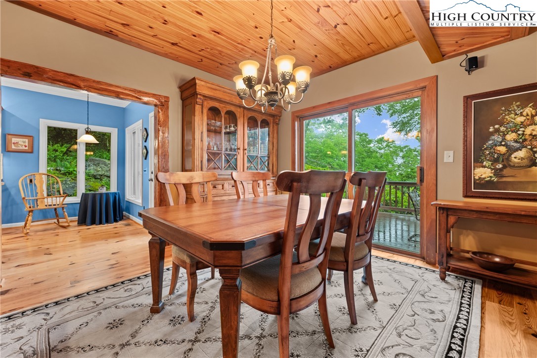 349 Belmont Drive Boone, NC 28607 - Photo 24 of 49 a view of a dining room with furniture a chandelier and wooden floor