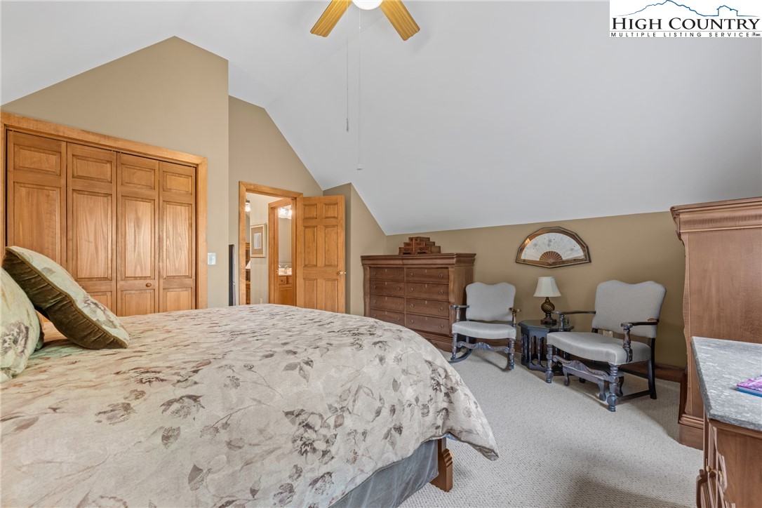 349 Belmont Drive Boone, NC 28607 - Photo 31 of 49 a bedroom with a bed and a chandelier