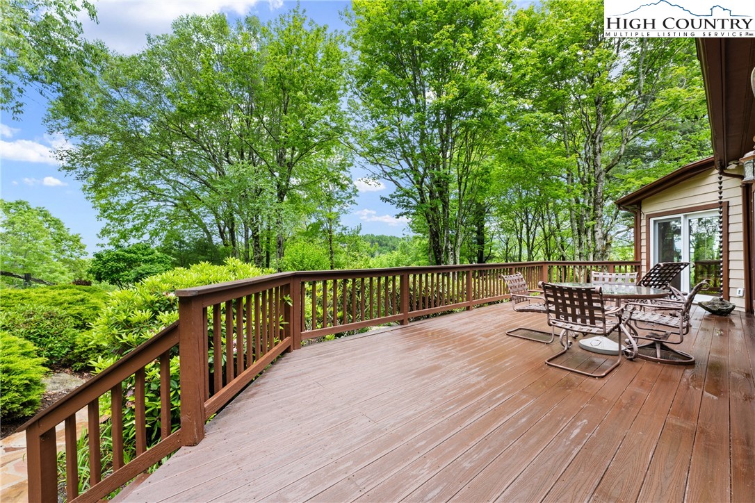 349 Belmont Drive Boone, NC 28607 - Photo 40 of 49 a view of two chairs and table on the wooden deck