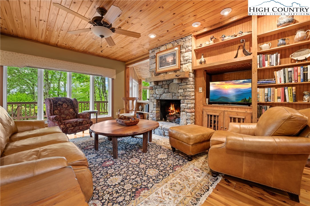 349 Belmont Drive Boone, NC 28607 - Photo 8 of 49 a living room with furniture a fireplace and a flat screen tv