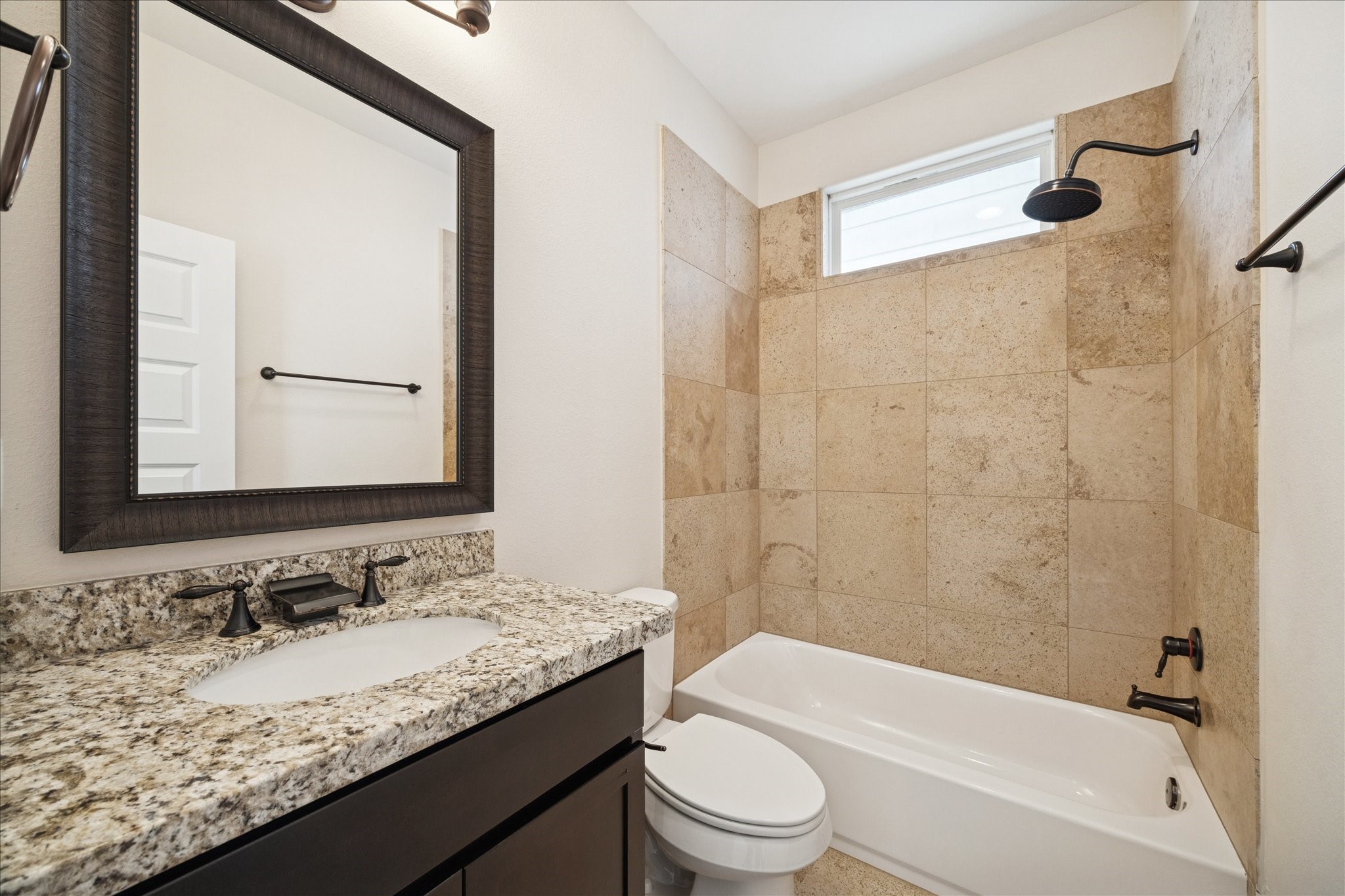 1546 West 23rd Street Houston, TX 77008 - Photo 17 of 20 a bathroom with a granite countertop sink a toilet and shower
