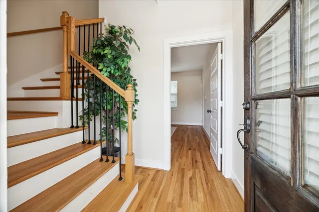 a view of entryway and hall with wooden floor