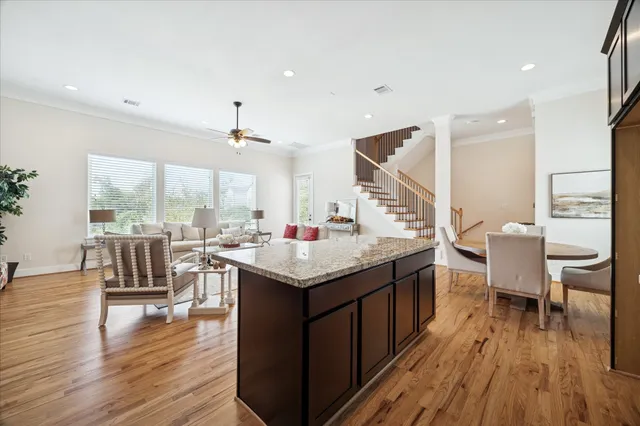 a kitchen with a table chairs and wooden floor