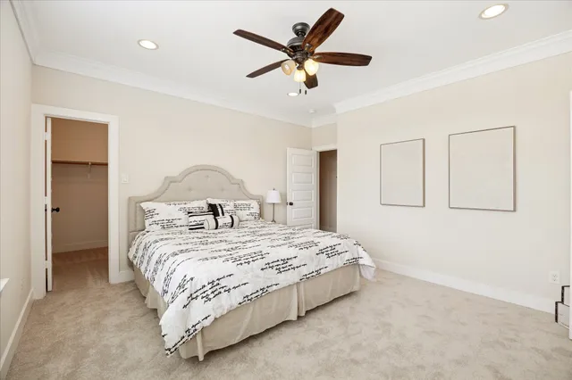 a bedroom with a bed and a ceiling fan