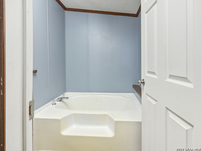 135 Savannah Ridge Von Ormy, TX 78073 - Photo 24 of 45 a bathroom with a white bath tub