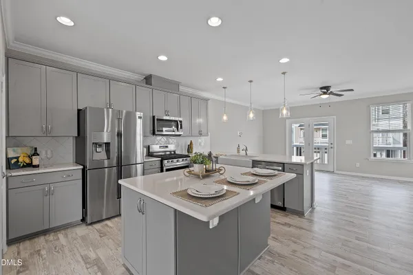 a kitchen with stainless steel appliances granite countertop a sink stove and refrigerator