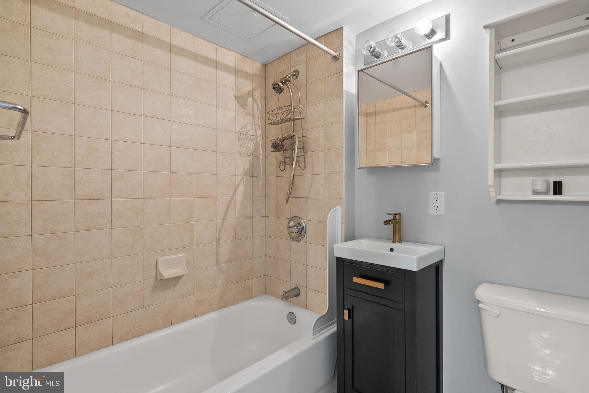 800 4th Street Southwest, Unit S513 Washington, DC 20024 - Photo 12 of 28 a bathroom with a sink a toilet and shower