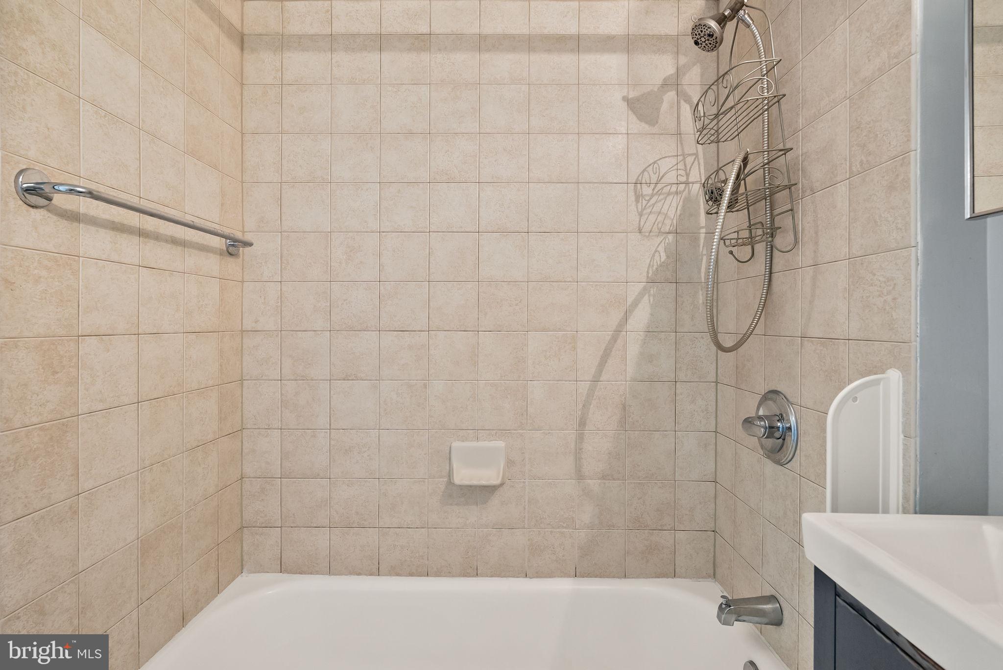800 4th Street Southwest, Unit S513 Washington, DC 20024 - Photo 13 of 28 a bathroom with a bathtub and shower