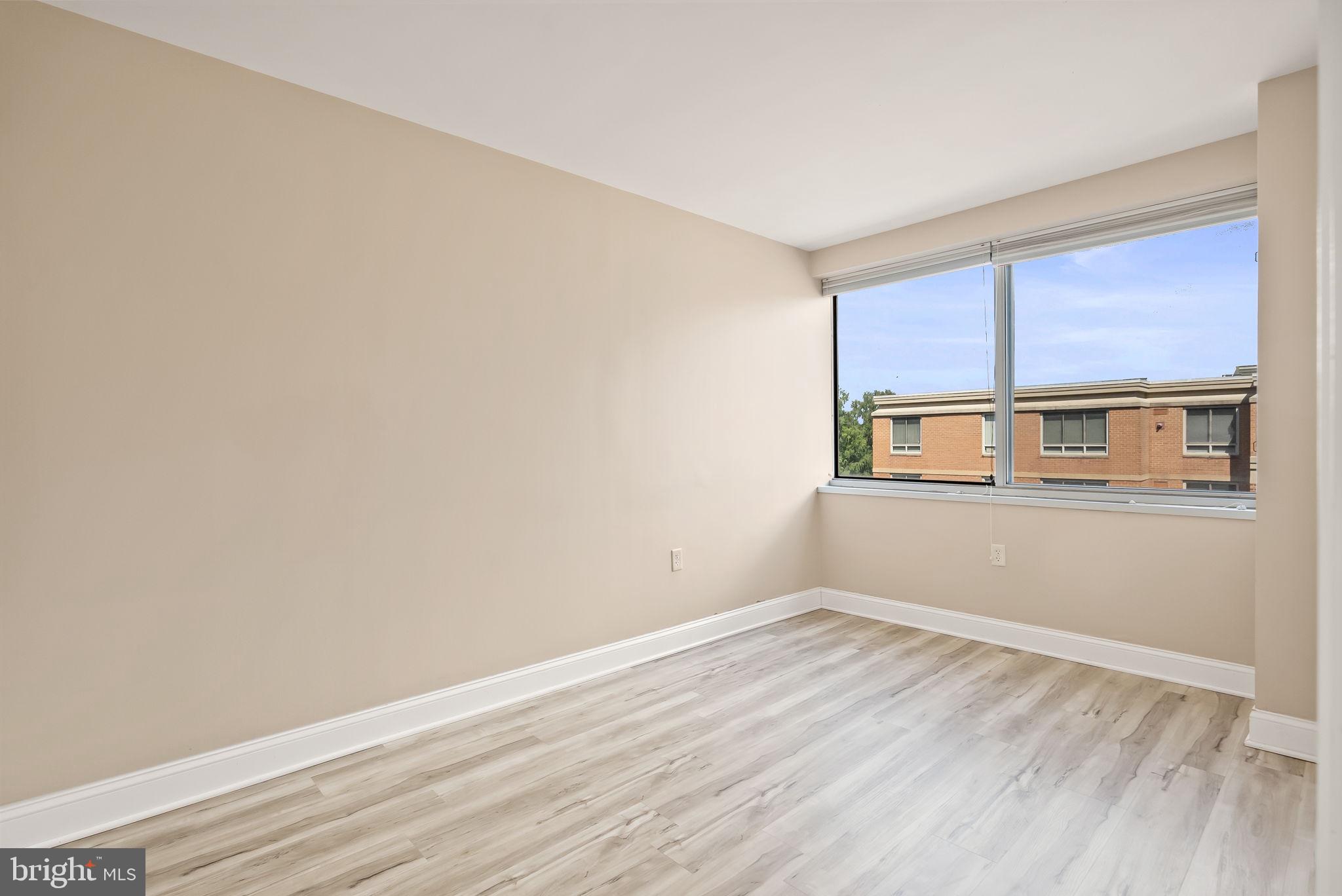 800 4th Street Southwest, Unit S513 Washington, DC 20024 - Photo 15 of 28 a view of an empty room with wooden floor and a window