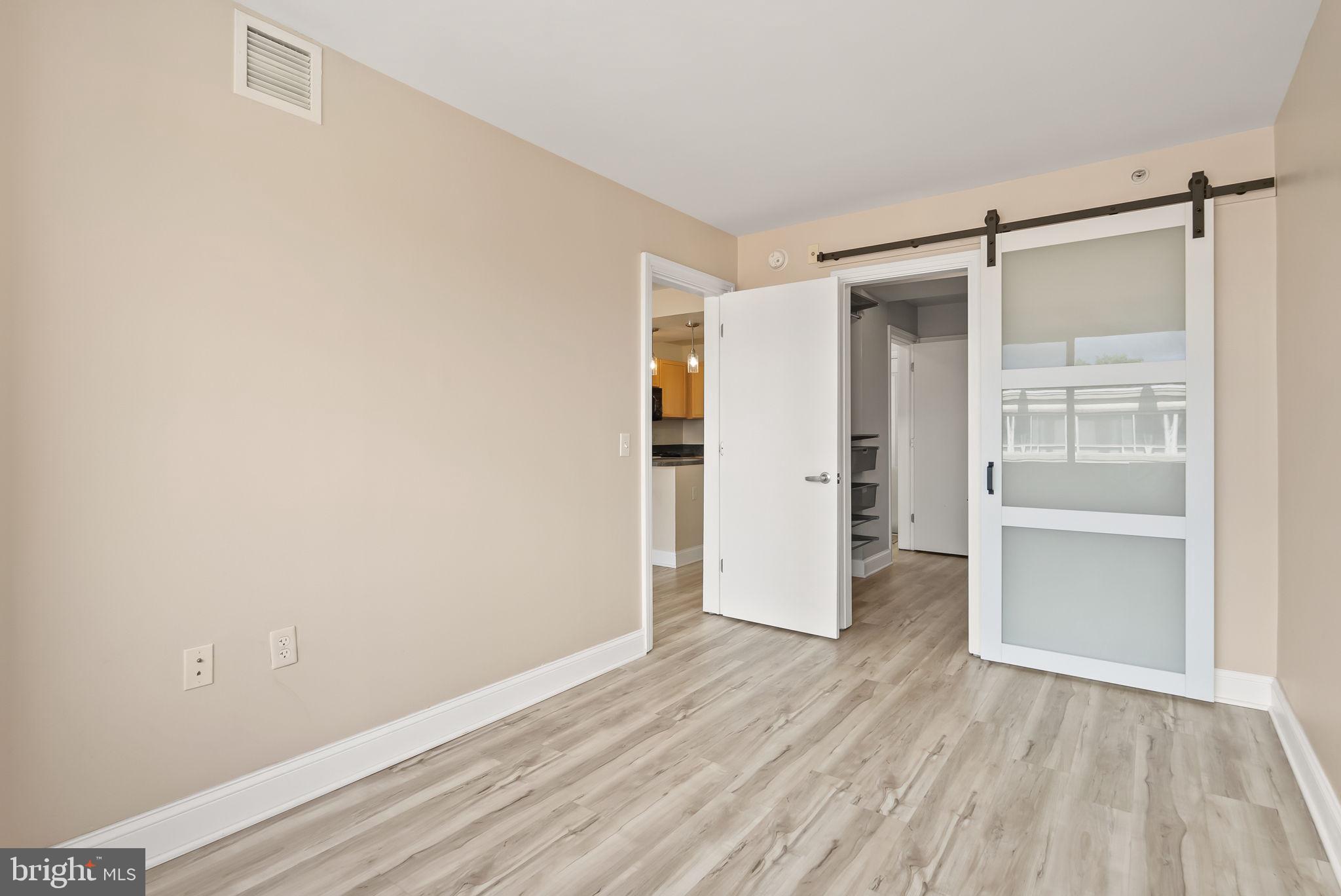 800 4th Street Southwest, Unit S513 Washington, DC 20024 - Photo 16 of 28 a view of an empty room with wooden floor closet and windows