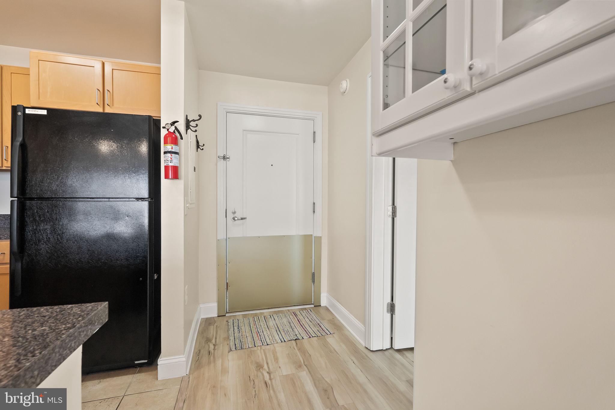 800 4th Street Southwest, Unit S513 Washington, DC 20024 - Photo 21 of 28 a view of kitchen with refrigerator cabinets and wooden floor