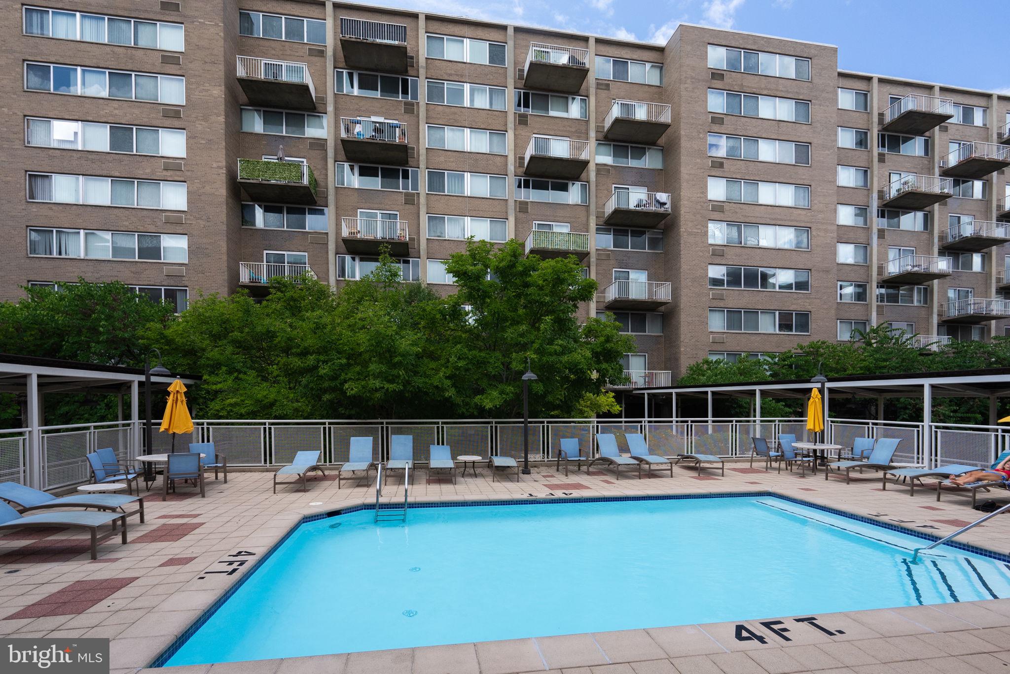 800 4th Street Southwest, Unit S513 Washington, DC 20024 - Photo 25 of 28 a view of a swimming pool with a lounge chairs