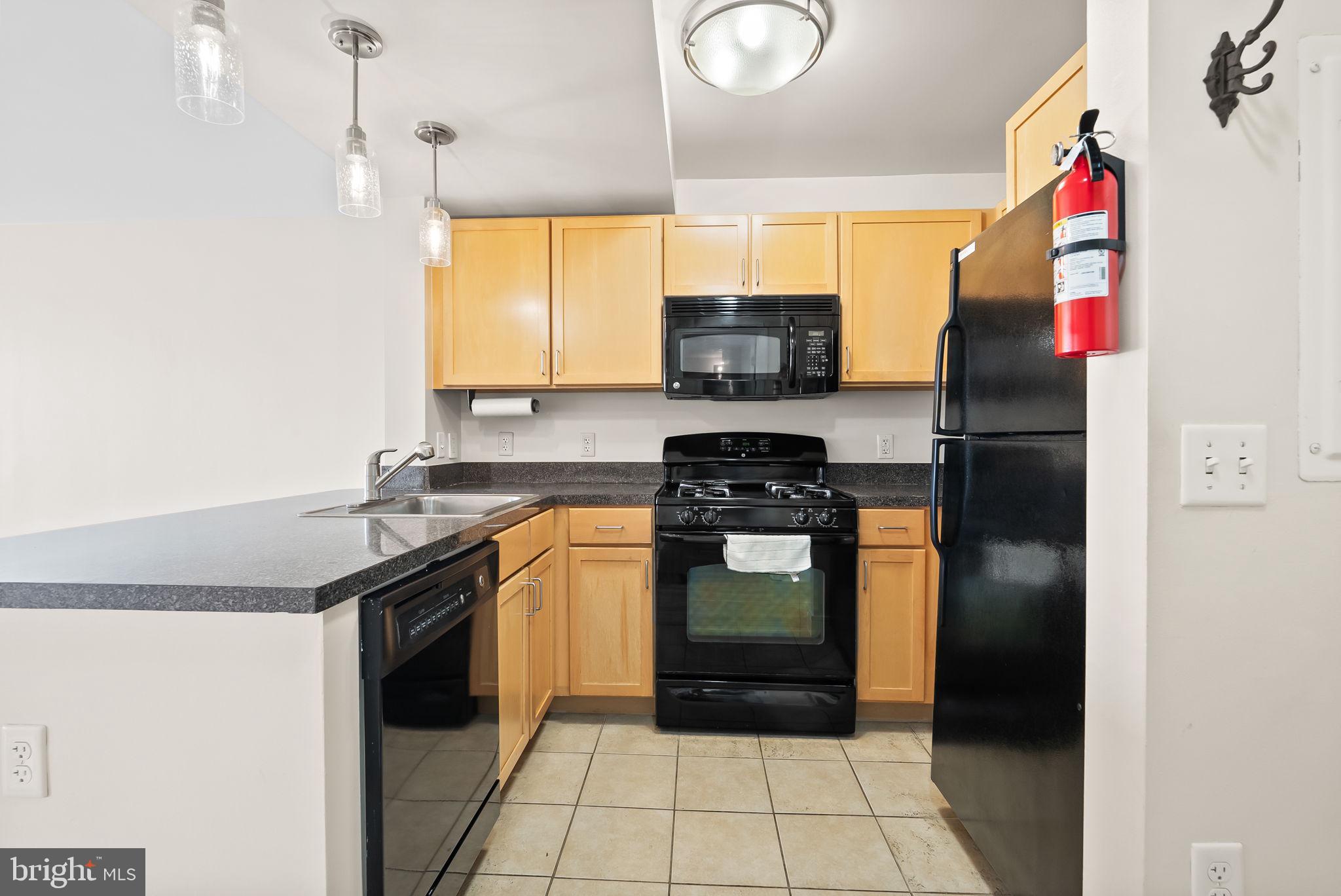 800 4th Street Southwest, Unit S513 Washington, DC 20024 - Photo 4 of 28 a kitchen with stainless steel appliances granite countertop a refrigerator and a sink