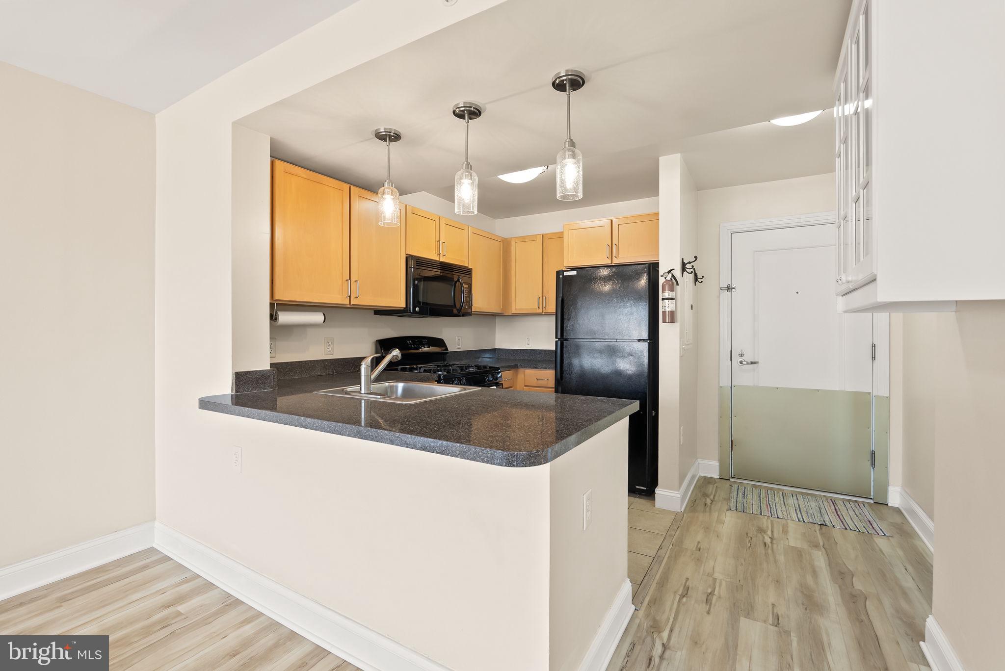 800 4th Street Southwest, Unit S513 Washington, DC 20024 - Photo 7 of 28 a kitchen with a refrigerator sink and cabinets