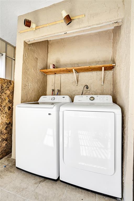 9273 Southwest 8th Street, Unit 117 Boca Raton, FL 33428 - Photo 17 of 40 a utility room with dryer and washer