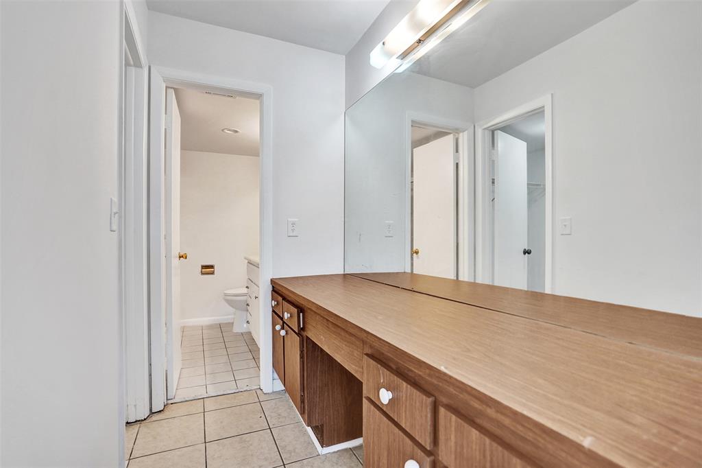 9273 Southwest 8th Street, Unit 117 Boca Raton, FL 33428 - Photo 19 of 40 a bathroom with a sink a toilet and a shower