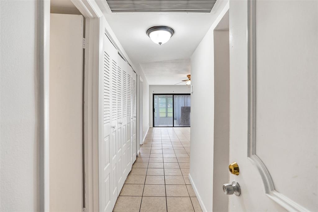 9273 Southwest 8th Street, Unit 117 Boca Raton, FL 33428 - Photo 2 of 40 a view of a hallway to a livingroom with furniture