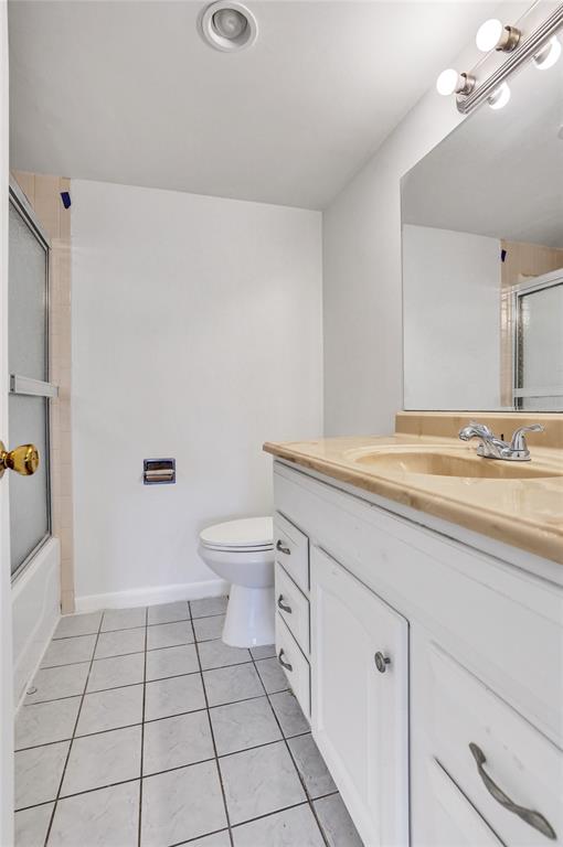9273 Southwest 8th Street, Unit 117 Boca Raton, FL 33428 - Photo 21 of 40 a spacious bathroom with a granite countertop sink a toilet and a mirror