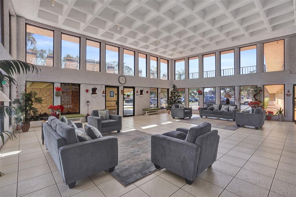 9273 Southwest 8th Street, Unit 117 Boca Raton, FL 33428 - Photo 28 of 40 a living room with furniture and a large window