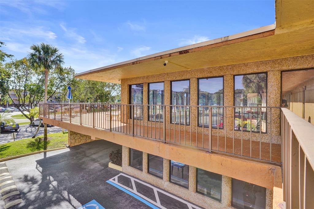 9273 Southwest 8th Street, Unit 117 Boca Raton, FL 33428 - Photo 34 of 40 a view of a building with a swimming pool