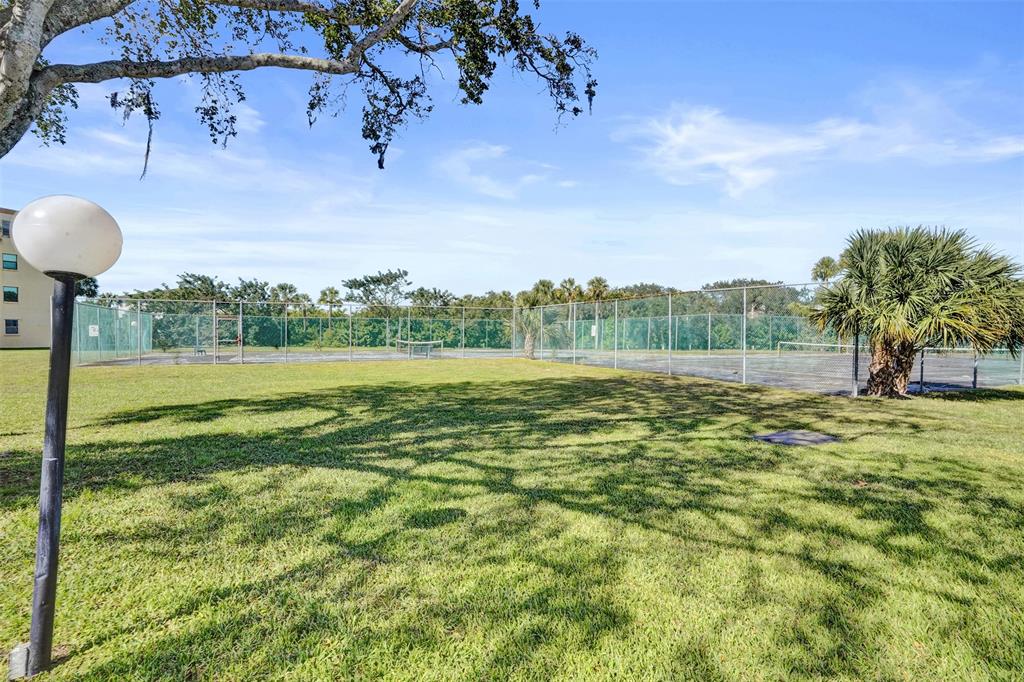 9273 Southwest 8th Street, Unit 117 Boca Raton, FL 33428 - Photo 36 of 40 a view of a park with large trees