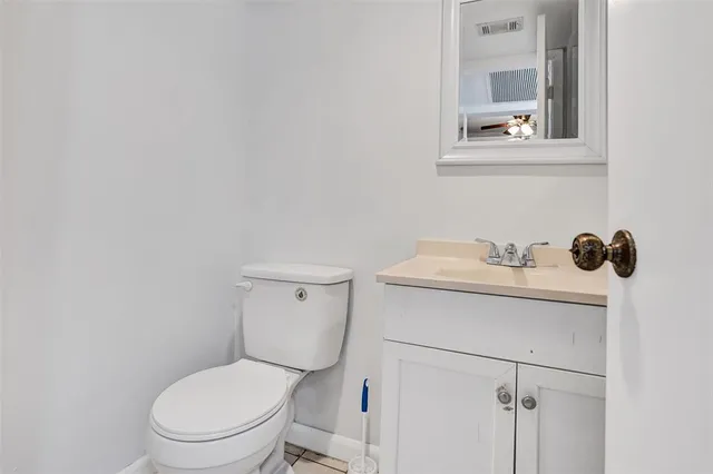 a white toilet sitting next to a bathroom sink