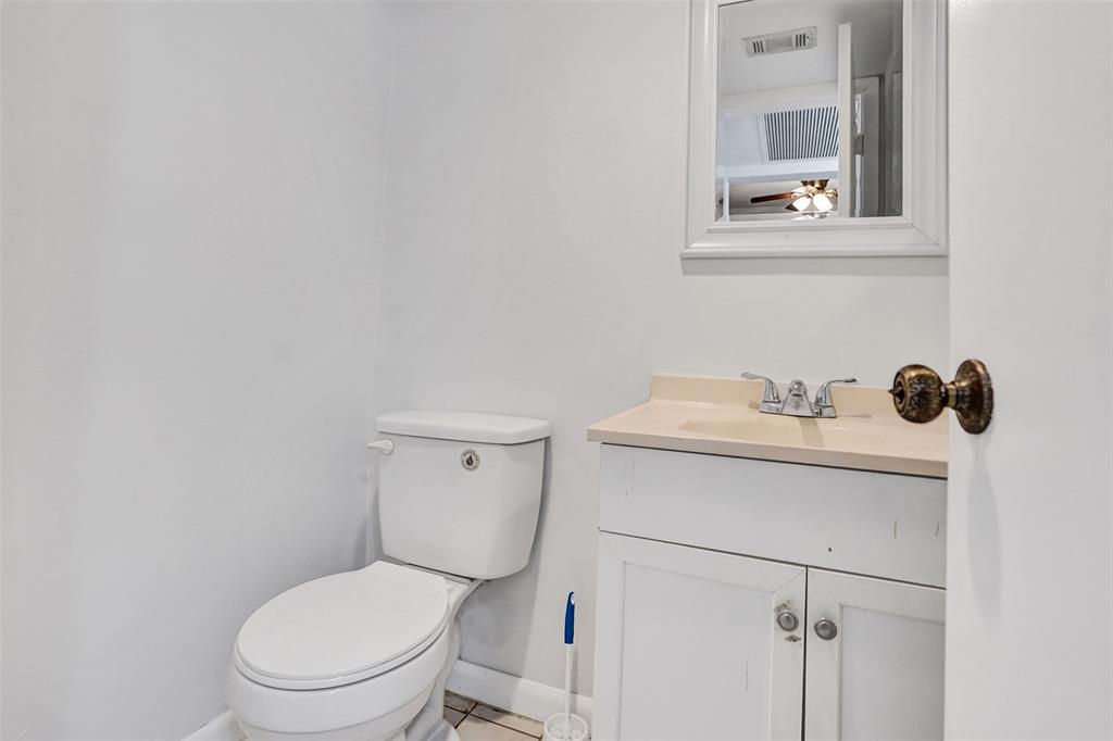 9273 Southwest 8th Street, Unit 117 Boca Raton, FL 33428 - Photo 4 of 40 a white toilet sitting next to a bathroom sink
