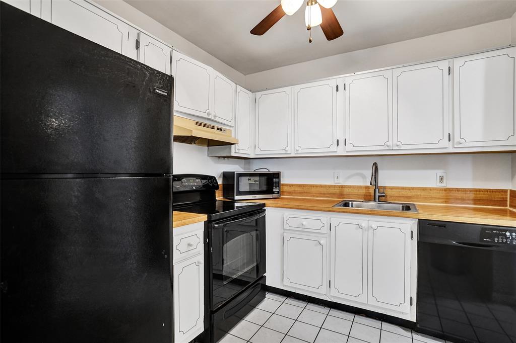 9273 Southwest 8th Street, Unit 117 Boca Raton, FL 33428 - Photo 7 of 40 a kitchen with stainless steel appliances granite countertop a refrigerator a sink dishwasher a stove and white cabinets