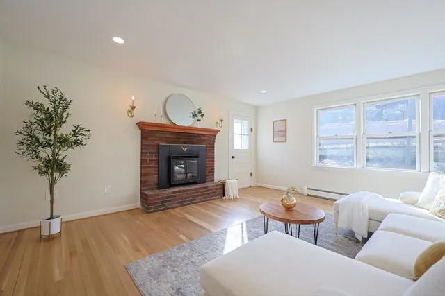 a living room with furniture a window and a fireplace