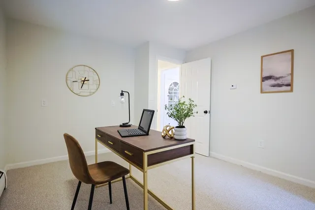 a view of a workspace with furniture and wooden floor